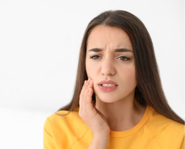 close up of woman feeling tooth sensitivity